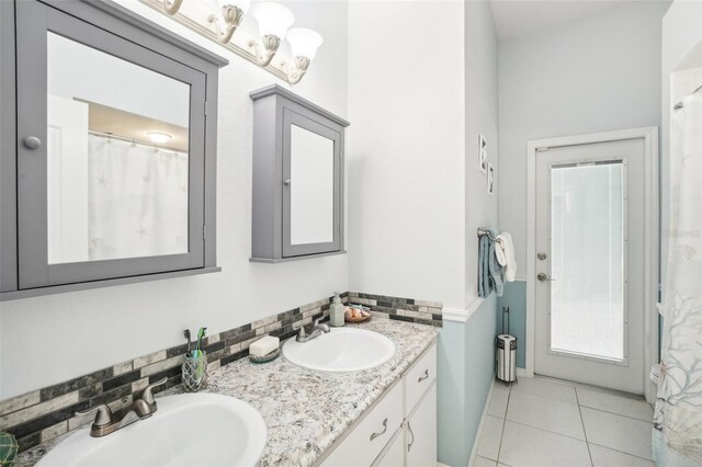 bathroom with vanity, decorative backsplash, and tile patterned floors