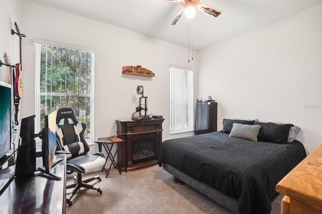 carpeted bedroom featuring ceiling fan and multiple windows