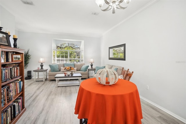 living room with an inviting chandelier, ornamental molding, and wood-type flooring