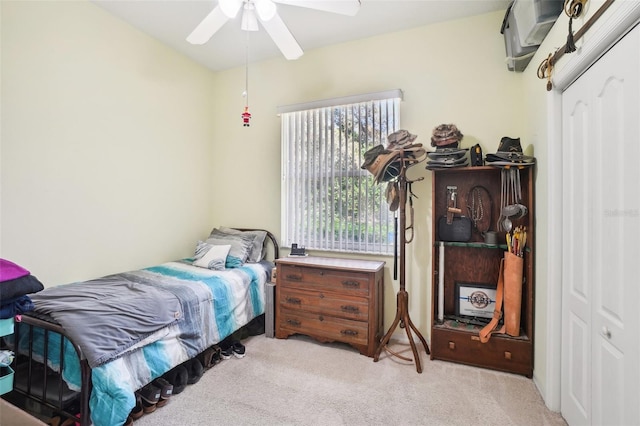 bedroom featuring a closet, ceiling fan, and light colored carpet