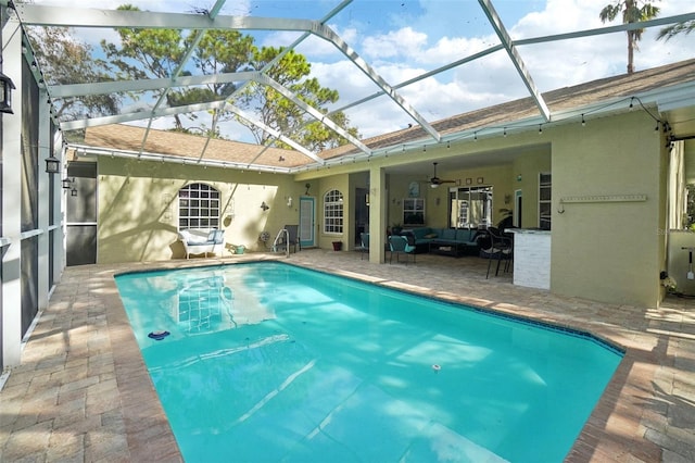 view of pool with a patio area, a lanai, and ceiling fan