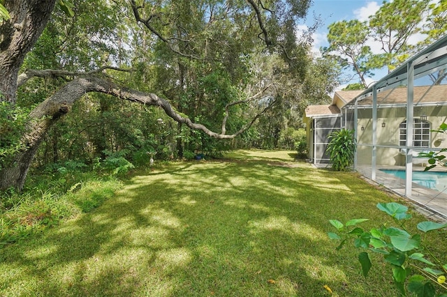 view of yard featuring glass enclosure