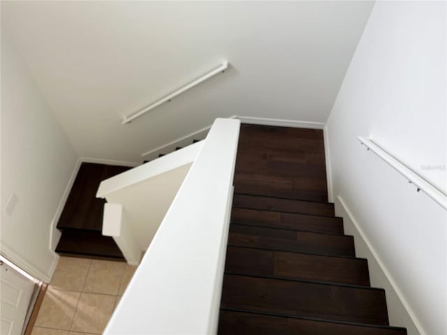 stairway featuring tile patterned flooring