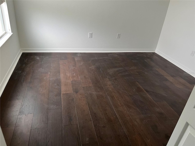 spare room featuring dark wood-type flooring