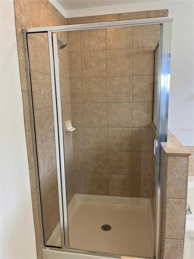 bathroom with a shower with shower door