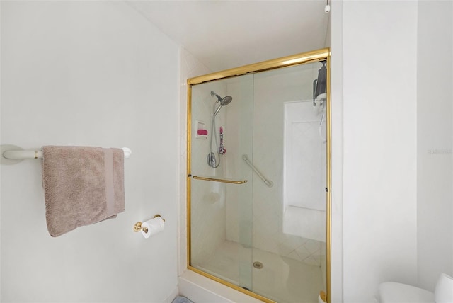 bathroom with toilet and walk in shower