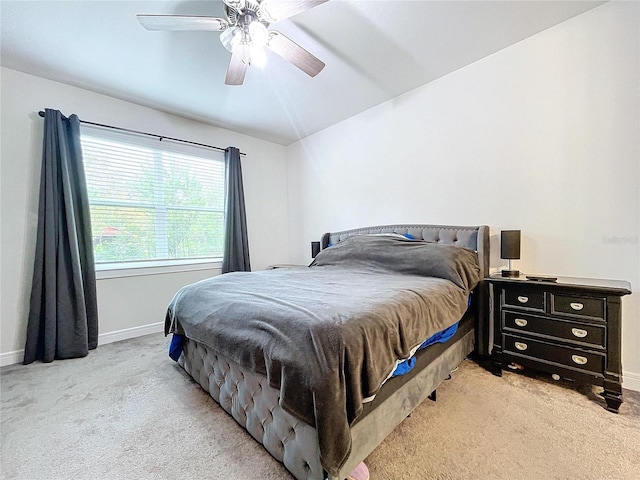 bedroom with light carpet and ceiling fan