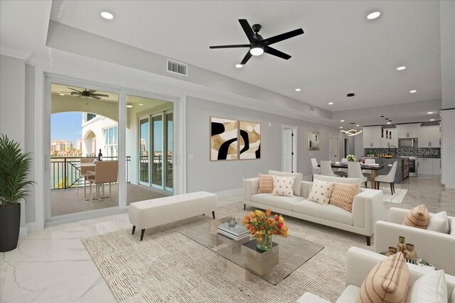 211 Dolphin Pt Unit 202, Clearwater Beach, FL 33767 - living area featuring a ceiling fan, light marble finish floors, recessed lighting, and baseboards