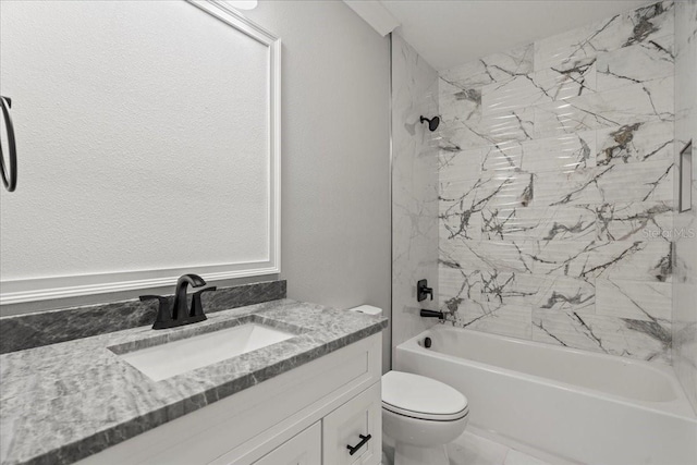 full bathroom featuring toilet, vanity, and tiled shower / bath