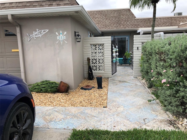 view of exterior entry with a garage