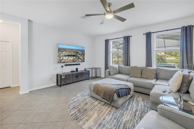 living room with ceiling fan, a wealth of natural light, and light tile patterned floors