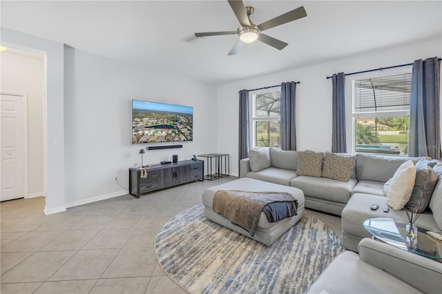 living area featuring light tile patterned floors, baseboards, a ceiling fan, and visible vents