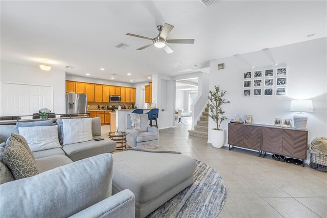 living area featuring ceiling fan, stairs, recessed lighting, baseboards, and light tile patterned floors