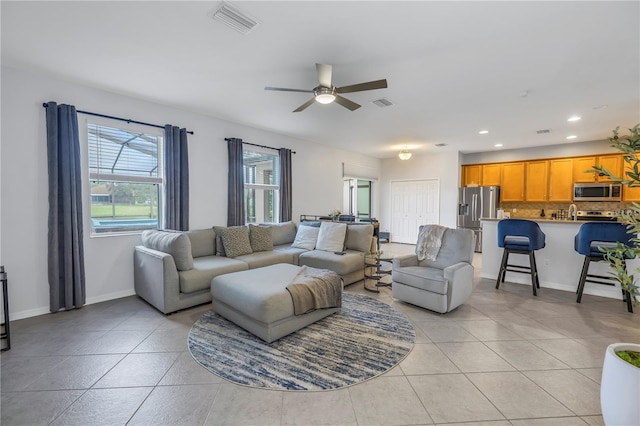 living room featuring ceiling fan, recessed lighting, light tile patterned flooring, and visible vents