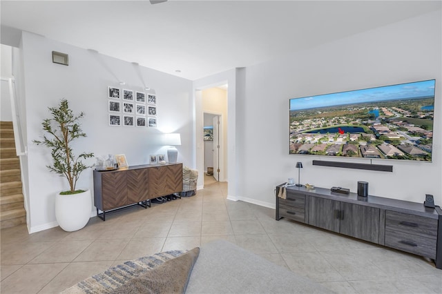interior space with light tile patterned floors, baseboards, and stairway