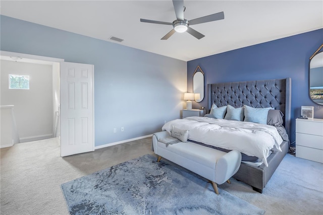 carpeted bedroom featuring visible vents, a ceiling fan, and baseboards