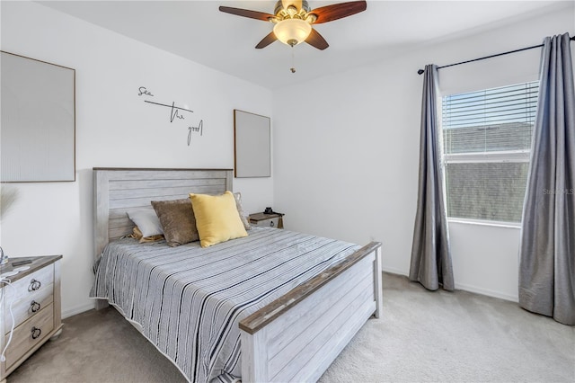 bedroom featuring light carpet and a ceiling fan