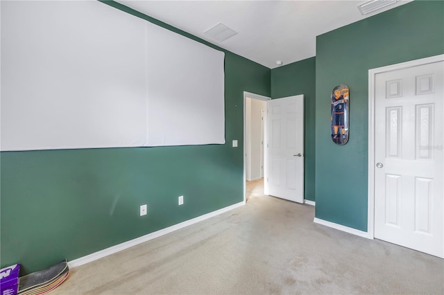 unfurnished bedroom with baseboards, carpet, and visible vents