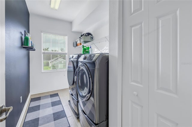 laundry area featuring separate washer and dryer, laundry area, and baseboards