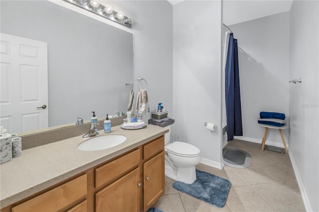 bathroom with vanity, curtained shower, toilet, and tile patterned flooring