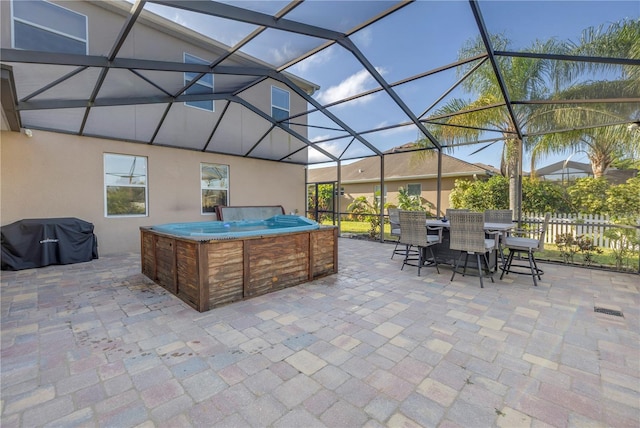 view of patio with a hot tub, grilling area, a lanai, and outdoor dining area