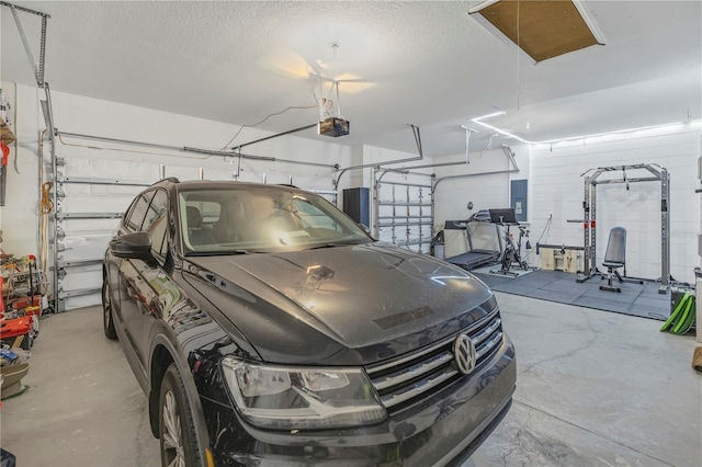 garage with a garage door opener and electric panel