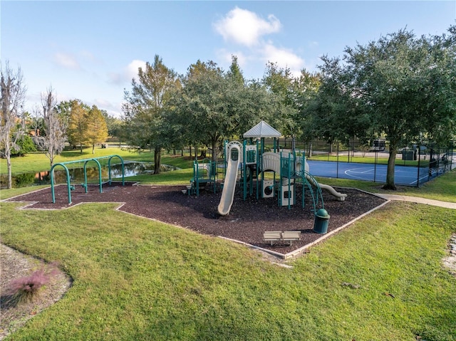 view of jungle gym with a water view and a lawn