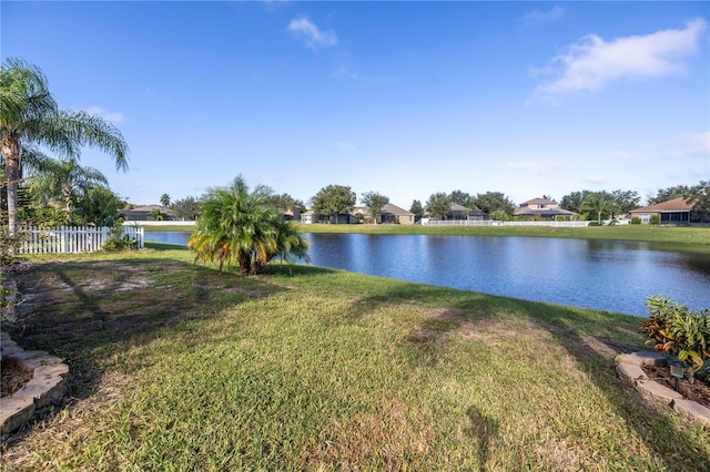 property view of water featuring fence and a residential view