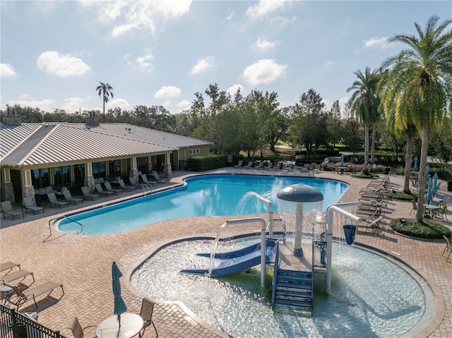 view of swimming pool featuring pool water feature and a patio area