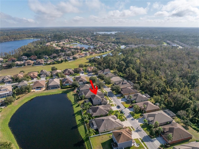 bird's eye view featuring a residential view, a water view, and a forest view