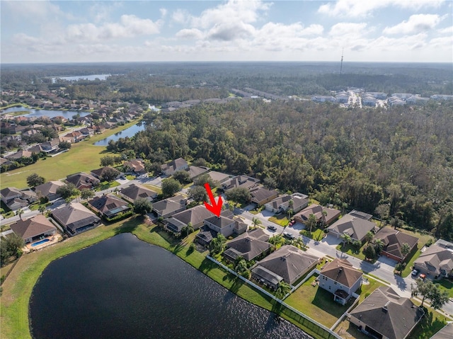 birds eye view of property featuring a water view, a residential view, and a forest view