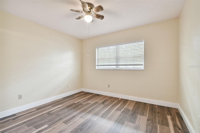 spare room with ceiling fan, hardwood / wood-style flooring, and a textured ceiling