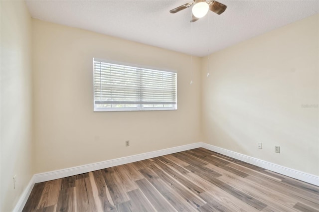 spare room featuring light hardwood / wood-style flooring, a textured ceiling, and ceiling fan