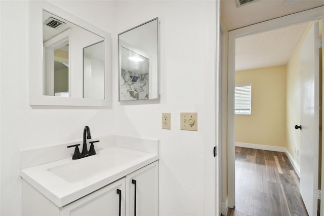 bathroom with vanity and hardwood / wood-style flooring