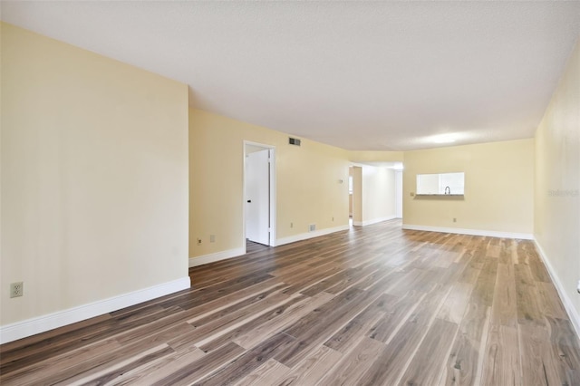 spare room featuring a textured ceiling and wood-type flooring