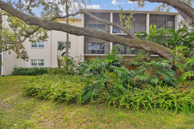 view of home's exterior with a sunroom