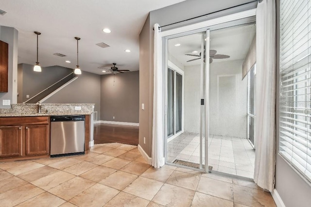 kitchen with light stone countertops, ceiling fan, hanging light fixtures, stainless steel dishwasher, and light tile patterned flooring