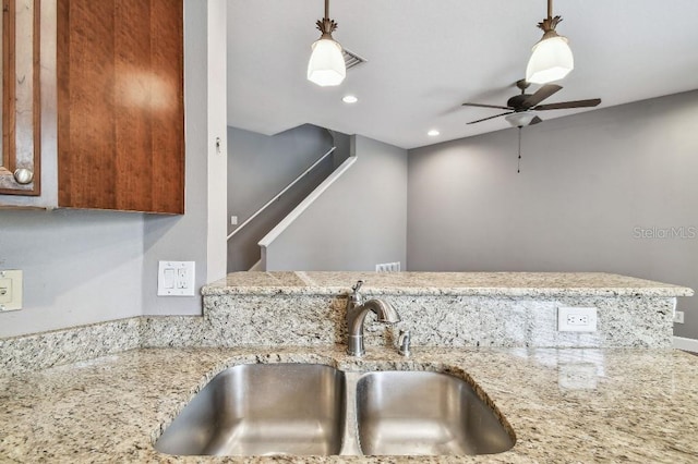 kitchen with pendant lighting, ceiling fan, and sink