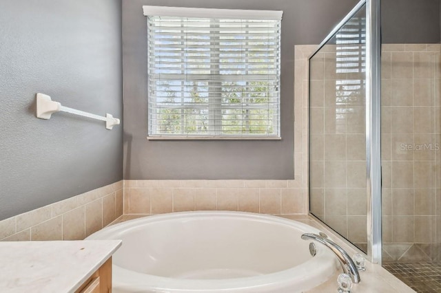 bathroom featuring separate shower and tub and vanity