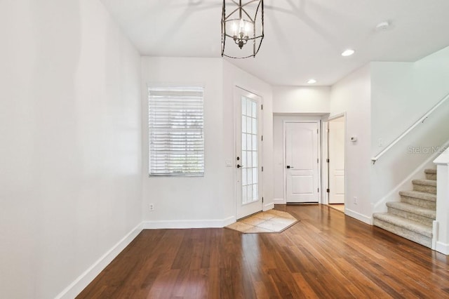 entryway with stairway, baseboards, wood finished floors, and recessed lighting