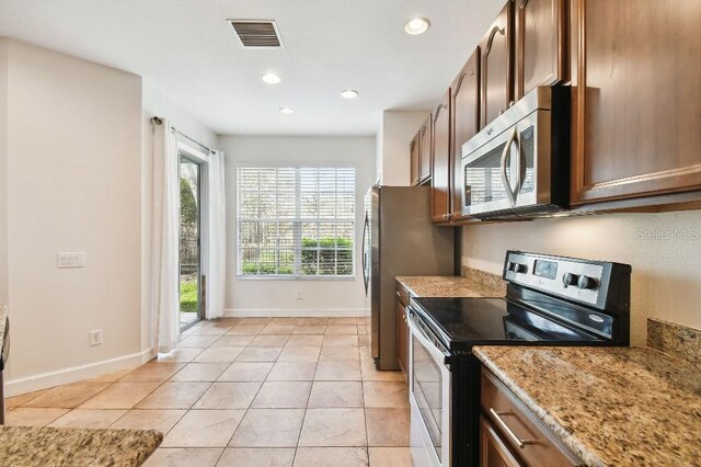 kitchen featuring visible vents, light stone countertops, light tile patterned flooring, stainless steel appliances, and recessed lighting