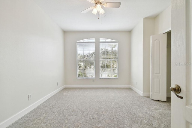 unfurnished room with light carpet, ceiling fan, and baseboards