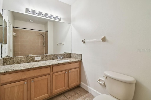 bathroom with toilet, vanity, a shower, and tile patterned floors