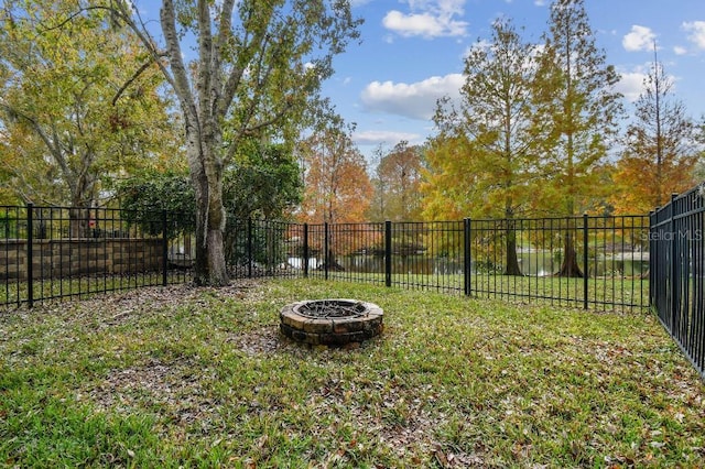 view of yard with an outdoor fire pit and fence