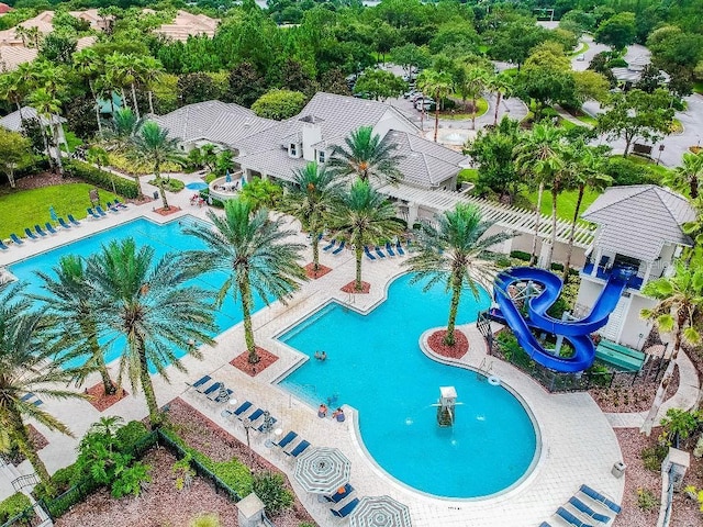 view of pool featuring a water slide and fence