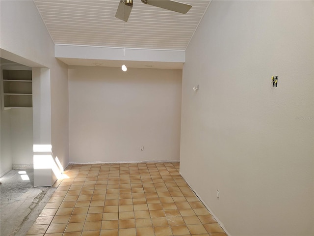 tiled spare room featuring ceiling fan