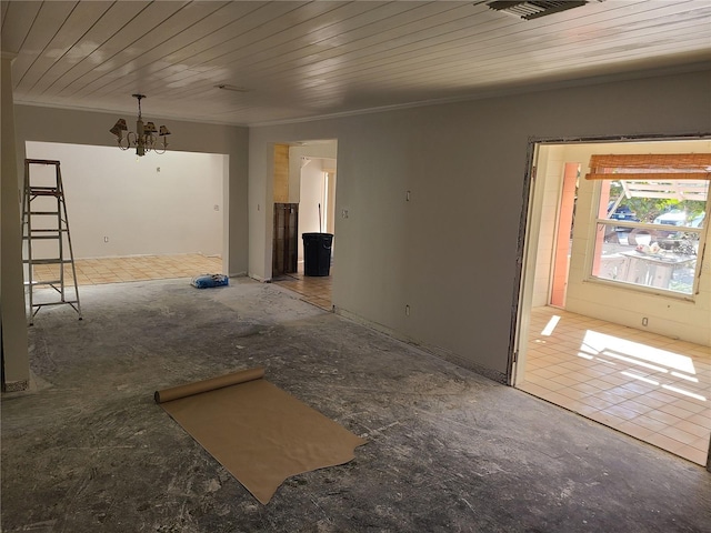 spare room featuring a chandelier