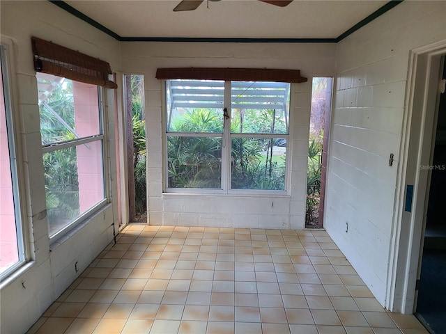 unfurnished sunroom with ceiling fan