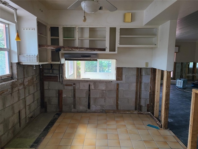 kitchen featuring water heater and a healthy amount of sunlight