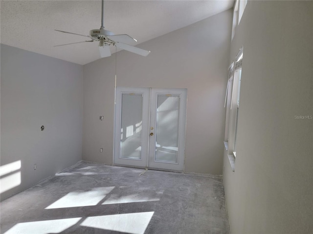 carpeted empty room with ceiling fan, a textured ceiling, high vaulted ceiling, and french doors